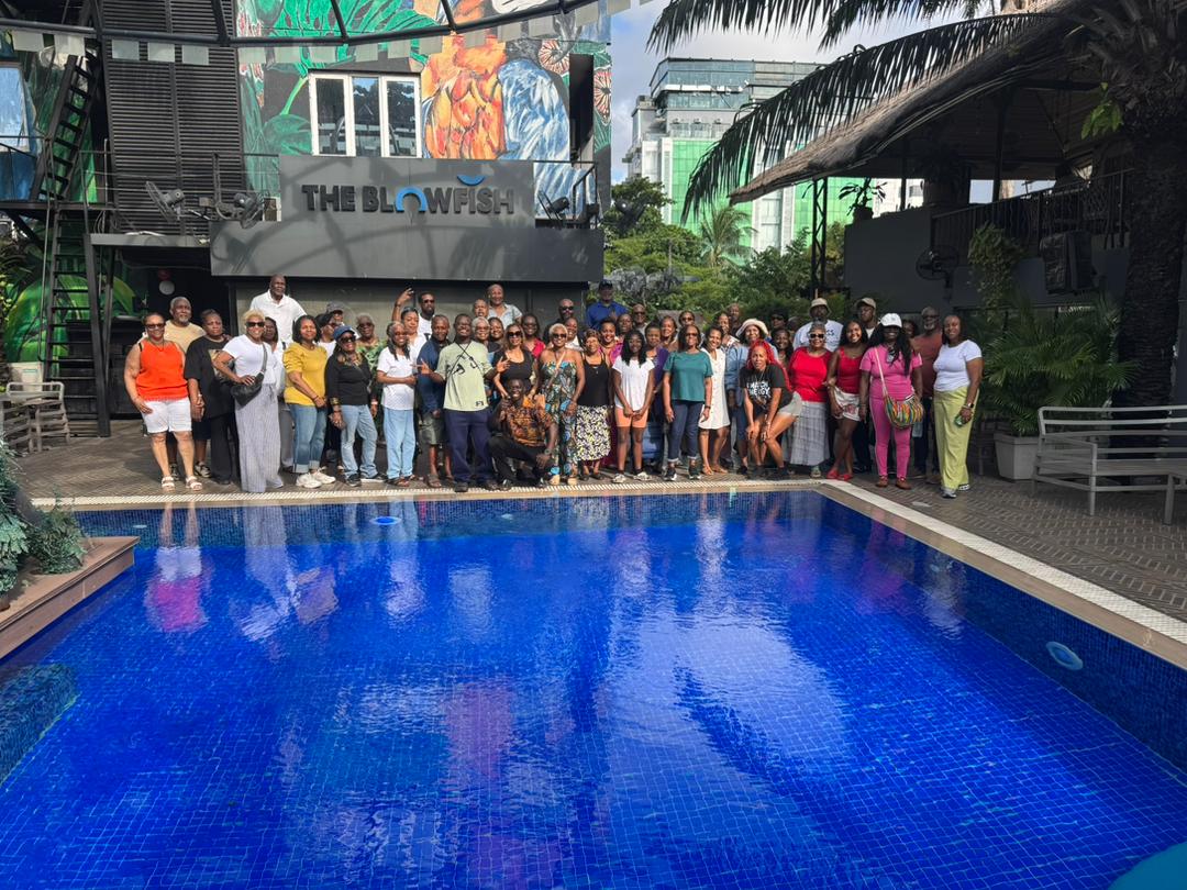 Benjamin and tour visitors posing together in Lagos